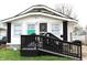 Charming home with black and white painted exterior, convenient access ramp and Ring security at 1311 N Denny St, Indianapolis, IN 46201