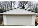 A single-car garage featuring a white door with paneled design and matching white siding at 1311 N Denny St, Indianapolis, IN 46201