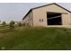 A spacious barn with a large sliding door and grassy surroundings at 13151 Walters Rd, Martinsville, IN 46151