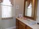 Bathroom with wooden vanity and framed mirror, plus natural light at 13151 Walters Rd, Martinsville, IN 46151