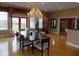 Bright dining room featuring a stunning chandelier, wood floors, and large windows overlooking the property at 13151 Walters Rd, Martinsville, IN 46151