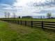 Scenic horse property with verdant pastures, classic wood fencing, and the main house in the distance at 13151 Walters Rd, Martinsville, IN 46151