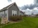Home exterior view highlighting backyard, grassy yard, and overcast skies at 13151 Walters Rd, Martinsville, IN 46151
