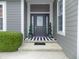 Inviting front entrance with sidelights, decorative plants, and stylish welcome mat at 13151 Walters Rd, Martinsville, IN 46151