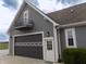 Home exterior featuring attached garage, small balcony and adjacent green shrubbery at 13151 Walters Rd, Martinsville, IN 46151
