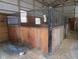 Close-up of a well-constructed horse stall in the barn, showing secure fencing and a partially open design at 13151 Walters Rd, Martinsville, IN 46151