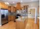 Well-appointed kitchen with an island, stainless steel appliances, granite countertops, and wood cabinets at 13151 Walters Rd, Martinsville, IN 46151