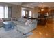 Open concept living room flows into the kitchen, featuring a large sectional and modern finishes at 13151 Walters Rd, Martinsville, IN 46151
