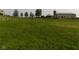 Scenic view of lush pasture with a horse grazing, surrounded by trees and a charming barn at 13151 Walters Rd, Martinsville, IN 46151