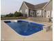 Inviting in-ground pool with a concrete deck and steps leading from the house at 13151 Walters Rd, Martinsville, IN 46151