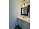 Powder room with a vanity, framed mirror, and modern lighting fixtures at 13993 Whittier Dr, Fishers, IN 46038