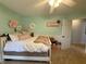Bright bedroom with fresh paint, a ceiling fan, and a decorative flower wall at 13993 Whittier Dr, Fishers, IN 46038