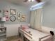 Charming bedroom featuring a pink toddler bed, tasteful decor, and natural light at 13993 Whittier Dr, Fishers, IN 46038
