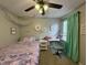 Cozy bedroom featuring a workspace area, complemented by a ceiling fan at 13993 Whittier Dr, Fishers, IN 46038