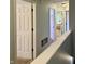 Hallway view showcasing multiple doors and a staircase, painted in a light color at 13993 Whittier Dr, Fishers, IN 46038