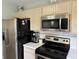 Well-equipped kitchen with stainless steel appliances and bright cabinets at 13993 Whittier Dr, Fishers, IN 46038