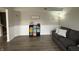 Cozy living room featuring gray sofa, hardwood floors, and cube storage unit at 13993 Whittier Dr, Fishers, IN 46038