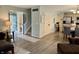 Inviting living room with light wood floors, open entry, and a view into the kitchen at 13993 Whittier Dr, Fishers, IN 46038
