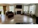 Cozy living room with a fireplace, large windows, and contemporary decor at 13993 Whittier Dr, Fishers, IN 46038