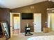 Spacious main bedroom features high ceilings, a mounted television, and access to the en-suite bathroom and closet at 13993 Whittier Dr, Fishers, IN 46038