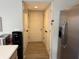 Hallway view of a pantry with double doors and stainless steel refrigerator at 13993 Whittier Dr, Fishers, IN 46038