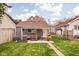 Backyard featuring a covered patio, a grill, and a well-maintained lawn, perfect for outdoor activities at 1429 Linden St, Indianapolis, IN 46203