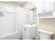 Bright white bathroom with a shower-tub combo, white vanity and medicine cabinet at 1429 Linden St, Indianapolis, IN 46203