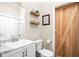 Bathroom featuring a white vanity with modern fixtures and a decorative barn door at 1429 Linden St, Indianapolis, IN 46203
