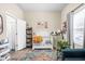 Bright Bedroom with crib, accent chair, playful décor, and natural light from the window at 1429 Linden St, Indianapolis, IN 46203