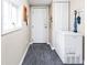 Functional entryway with coat hooks, freezer, a window with natural light, and a neutral color scheme at 1429 Linden St, Indianapolis, IN 46203