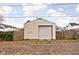 Detached garage with a roll-up door and a wooden fence surround providing privacy at 1429 Linden St, Indianapolis, IN 46203