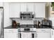 Close up of the stainless steel oven, microwave and stove in a kitchen with white cabinets at 1429 Linden St, Indianapolis, IN 46203
