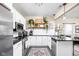 Bright kitchen with white cabinets, granite counters, stainless appliances, and decorative open shelving at 1429 Linden St, Indianapolis, IN 46203