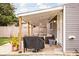 Covered patio with outdoor seating, a grill, and string lights, ideal for relaxing and dining at 1429 Linden St, Indianapolis, IN 46203