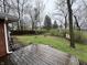 Spacious backyard with grass, bare trees, and a wooden fence at 1509 N Mann Ave, Muncie, IN 47304