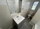 The bathroom features a new gray vanity, tile floors, tiled walls and a bath-shower combination at 1509 N Mann Ave, Muncie, IN 47304