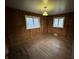 Traditional bedroom features hardwood floors, wood paneled walls and natural light from two windows at 1509 N Mann Ave, Muncie, IN 47304