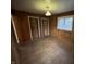 Classic bedroom with wood walls boasts hardwood floors, lighting fixture and natural light from a window at 1509 N Mann Ave, Muncie, IN 47304