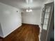 Dining room features wood floors, white walls, and modern chandelier at 1509 N Mann Ave, Muncie, IN 47304