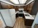 Traditional kitchen features wood cabinets, updated appliances, and durable flooring at 1509 N Mann Ave, Muncie, IN 47304
