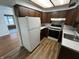 Traditional kitchen features wood cabinets, updated appliances, and durable flooring at 1509 N Mann Ave, Muncie, IN 47304