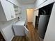 Functional laundry room with washer, dryer, and convenient overhead cabinetry, plus water heater, offers practicality at 1509 N Mann Ave, Muncie, IN 47304