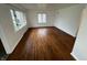Bright living room with hardwood floors, white trim, and abundant natural light at 1509 N Mann Ave, Muncie, IN 47304