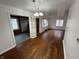 Spacious living room with hardwood floors, built-in cabinet, and lots of natural light at 1509 N Mann Ave, Muncie, IN 47304