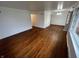Open living room featuring hardwood flooring, neutral paint, and large windows at 1509 N Mann Ave, Muncie, IN 47304