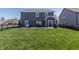 Spacious backyard with a well-maintained lawn, black fence, and an outdoor dining area with a pergola at 15493 Kennewick, Noblesville, IN 46062