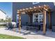 A backyard patio with a pergola, outdoor seating, and well-maintained lawn for outdoor gatherings at 15493 Kennewick, Noblesville, IN 46062