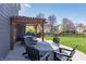 A backyard patio with a pergola, outdoor seating, and well-maintained lawn for outdoor gatherings at 15493 Kennewick, Noblesville, IN 46062