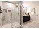 Elegant bathroom features a glass shower with marble tile, modern fixtures, and a double sink vanity at 15493 Kennewick, Noblesville, IN 46062