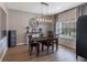 Bright dining room with wood flooring, a farmhouse style sideboard, and a modern light fixture at 15493 Kennewick, Noblesville, IN 46062